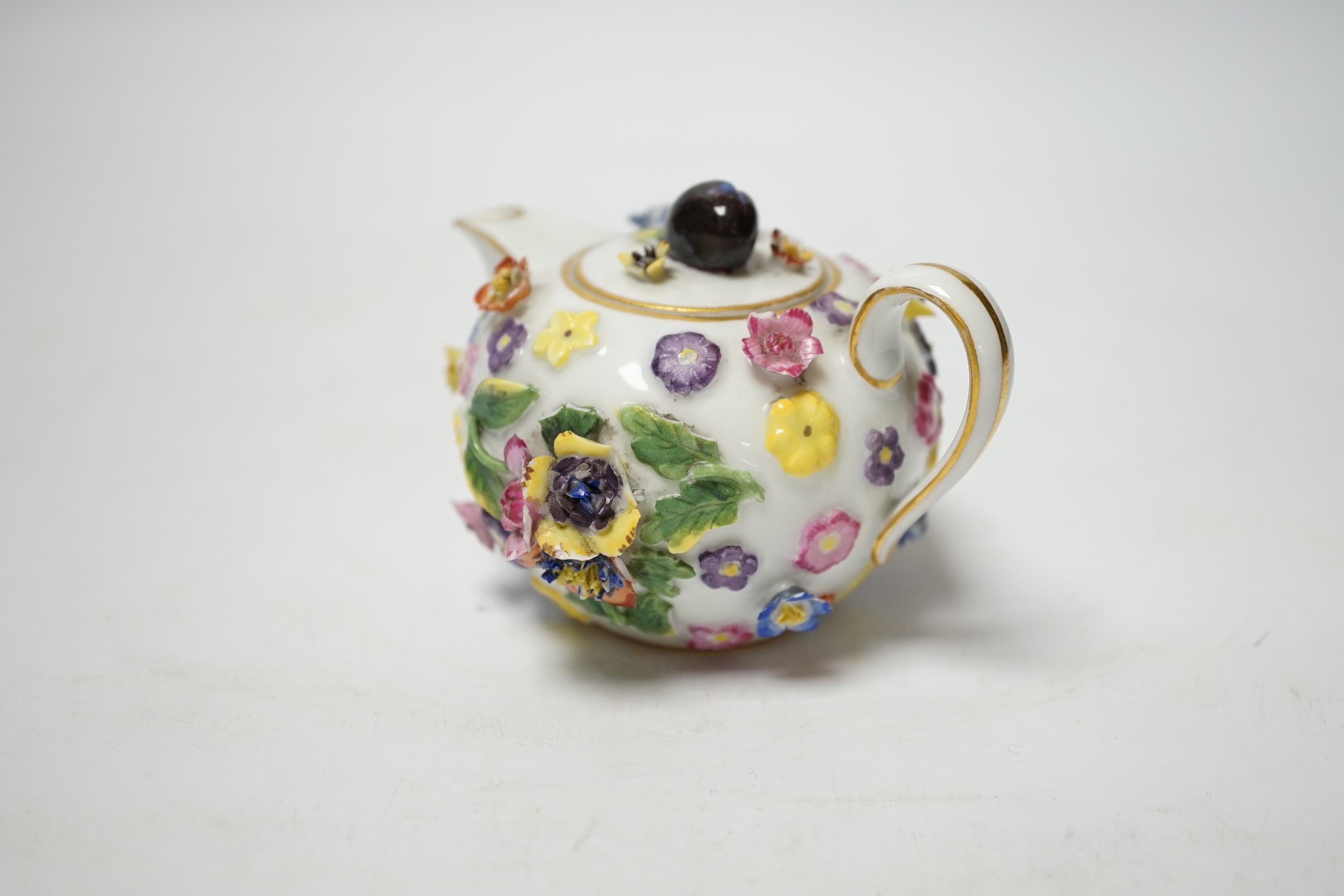 A miniature Meissen floral encrusted teapot, 7cm